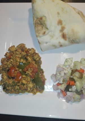 A picture of Chicken Qeema Tomato and Green Bell Pepper with chacumar Salad.