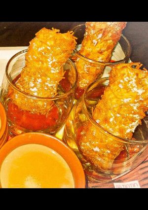 A picture of Kurkure cheese pockets with sweet and salty dip.