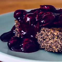 A picture of Vegan Poppyseed Pie with Cherry Sauce.