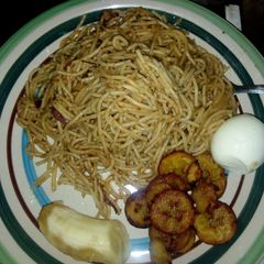A picture of Spagetti jollof with fried rice and egg.