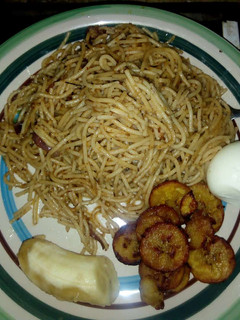 A picture of Spagetti jollof with fried rice and egg.