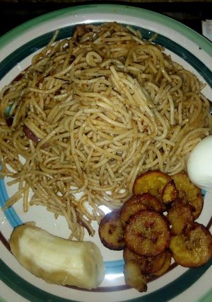 A picture of Spagetti jollof with fried rice and egg.