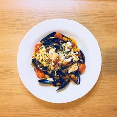 A picture of Cod, mussels and chorizo in garlic butter and white wine sauce.