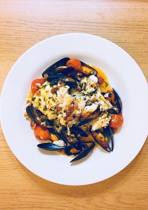 A picture of Cod, mussels and chorizo in garlic butter and white wine sauce.