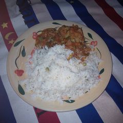 A picture of Rice and chicken sauce.