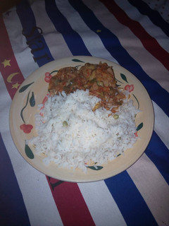 A picture of Rice and chicken sauce.
