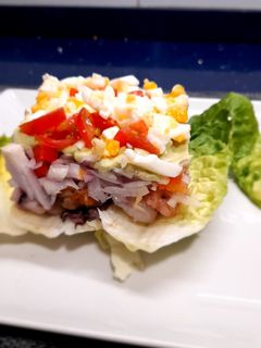 Una foto de Timbal de marisco sobre lechuga baby