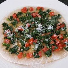 A picture of Spinach pizza baked on pan.