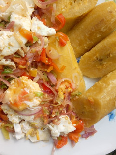 A picture of Unripe plantain with stir fry veggies poached eggs.