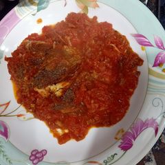 A picture of Red tomatoes chutney with fish.