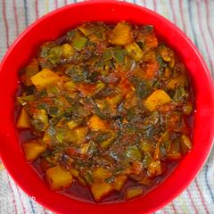 A picture of Green spring onion potato and tomato हरे प्याज आलू टमाटर कीसब्जी.