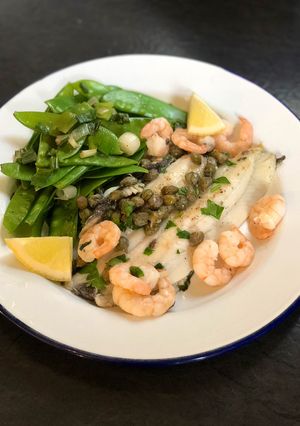 A picture of Lemon sole, capers, prawns and mangetout.