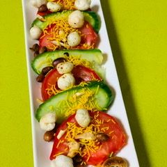 A picture of Tomato Cucumber and nuts salad.