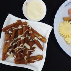 A picture of Baby Corn fingers with cheesy dip.