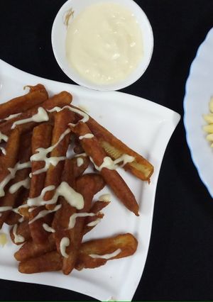 A picture of Baby Corn fingers with cheesy dip.