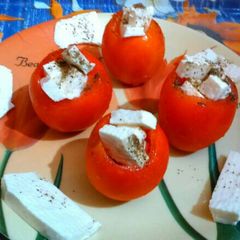 A picture of Caprese stuffed tomatoes.