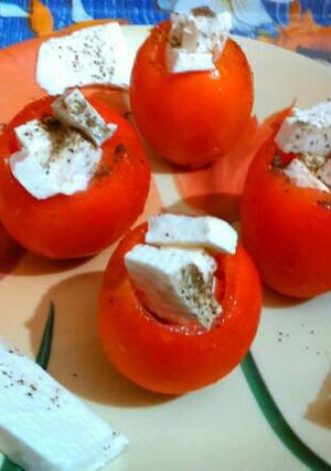 A picture of Caprese stuffed tomatoes.