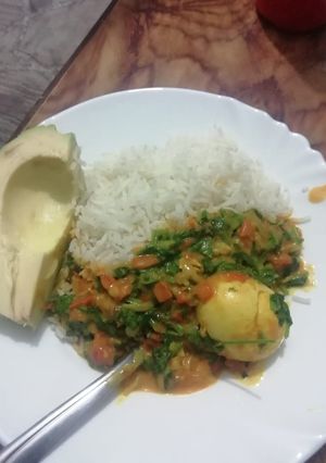 A picture of Rice Egg Curry And Avacado.