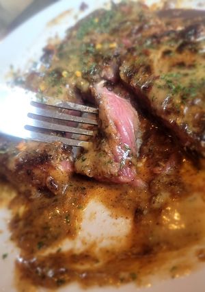 A picture of T-Bone Steak on Toast w/Creamed Drip Sauce & Red Pepper +Parsley.