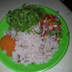 A picture of Rice and beans with salad.