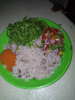 A picture of Rice and beans with salad.
