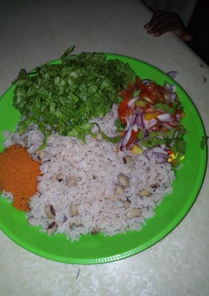 A picture of Rice and beans with salad.