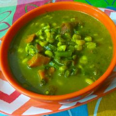 A picture of Veggies with green gravy.
