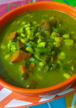 A picture of Veggies with green gravy.