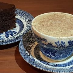 A picture of Chocolate fudge cake with a cup of coffee.