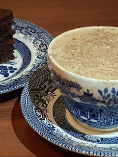 A picture of Chocolate fudge cake with a cup of coffee.