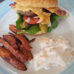 A picture of Homemade cheese burger with sweet potato chips.