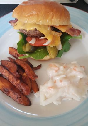 A picture of Homemade cheese burger with sweet potato chips.