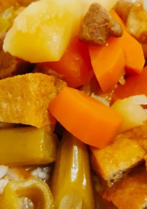 A picture of Stewed vegetables with roasted meat.