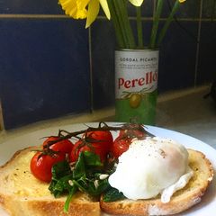 A picture of Breakfast Idea: poached egg with baked tomatoes 🍅.