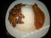A picture of rice with stew and plantain