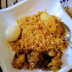 A picture of Jollof rice with Irish potatoes.