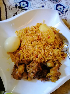 A picture of Jollof rice with Irish potatoes.