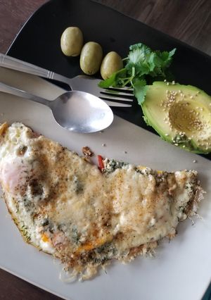 A picture of Fried eggs with cheese and avocado.