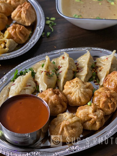 A picture of Steamed & Fried Chicken Momos (Dumplings).