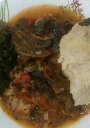A picture of Stewed Cut fish served with ugali and traditional greens.