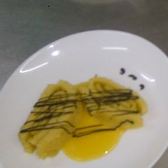 A picture of Swiss roll served with passion fruit sauce.