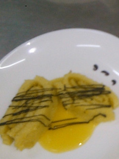 A picture of Swiss roll served with passion fruit sauce.