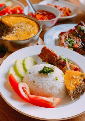 A picture of Vietnamese Broken Rice with Grilled Pork Chop, Egg Meatloaf, and Fried Egg.
