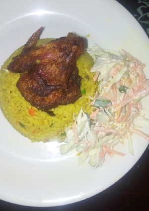 A picture of Fried rice, salad and chicken.