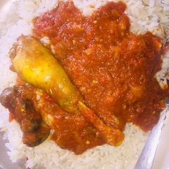 A picture of White rice with chicken stew.