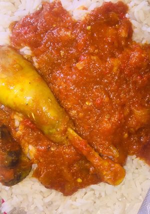 A picture of White rice with chicken stew.