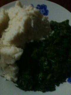 A picture of Ugali with spinach and terere.