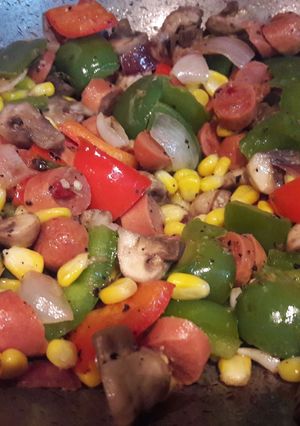 A picture of Chicken sausage fry  with mushrooms and veggies.