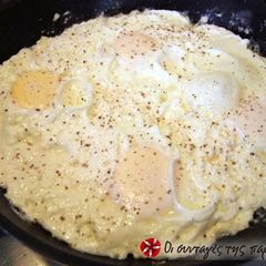 A picture of Eggs cooked with feta cheese.