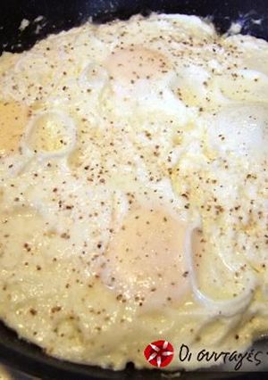 A picture of Eggs cooked with feta cheese.